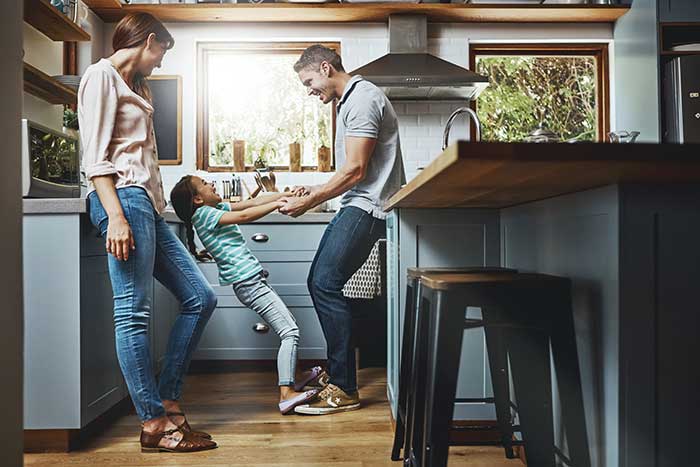 family playing in kitchen